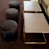 gold rectangular coffee table with black marble table top with black velvet ottoman stool at an event